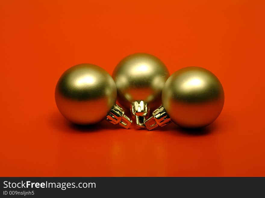 Gold christmas balls on red