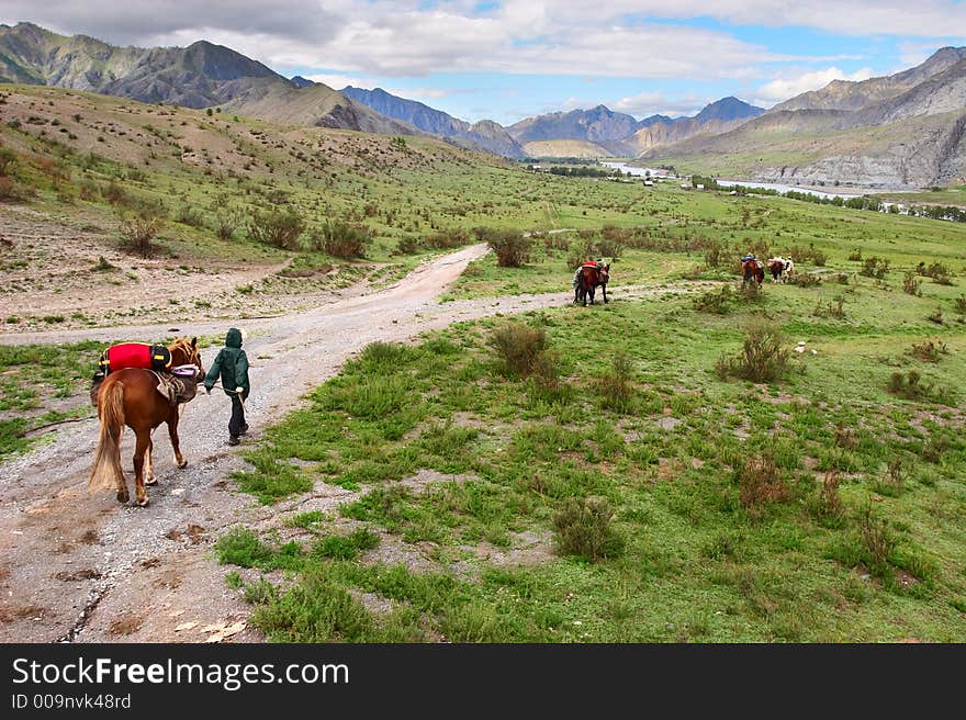 Road, mountains, horse and women.