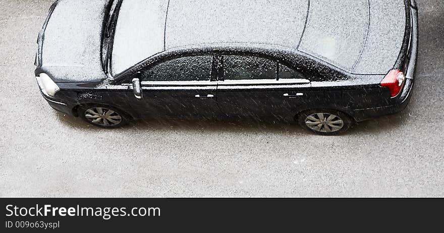 The automobile of a business-class covered by snow on a parking. The automobile of a business-class covered by snow on a parking