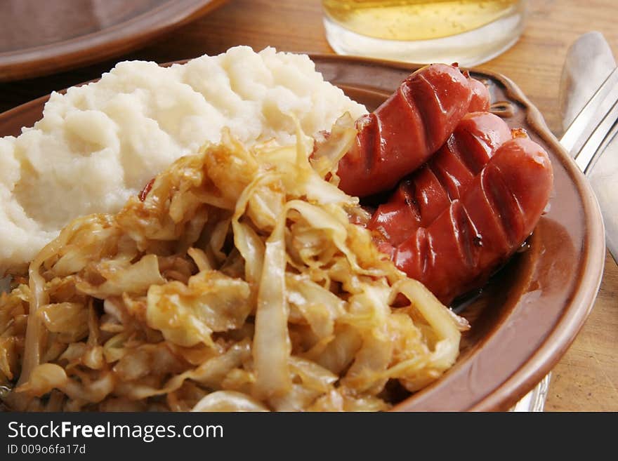 Frankfurters with fried cabbage and potatoes. Frankfurters with fried cabbage and potatoes.