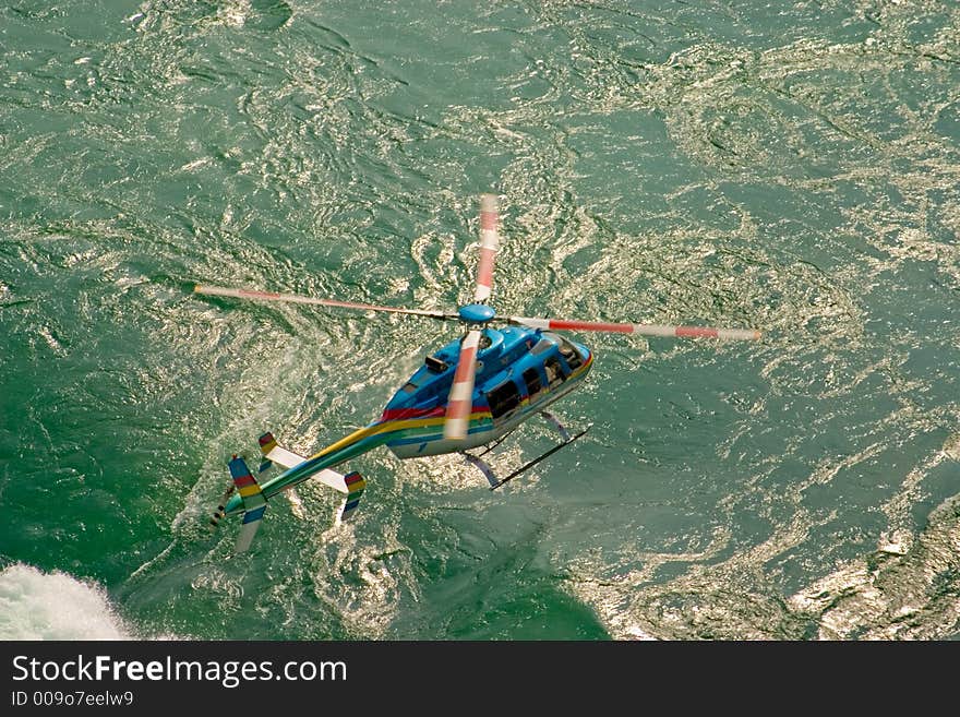 Helicopter Flying over a fast moving river.