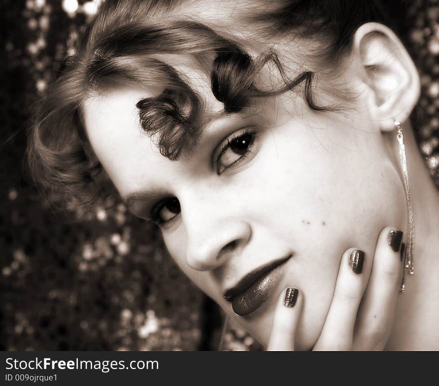 Beautiful young girl with a shimmery backdrop. Sepia toned. Beautiful young girl with a shimmery backdrop. Sepia toned.