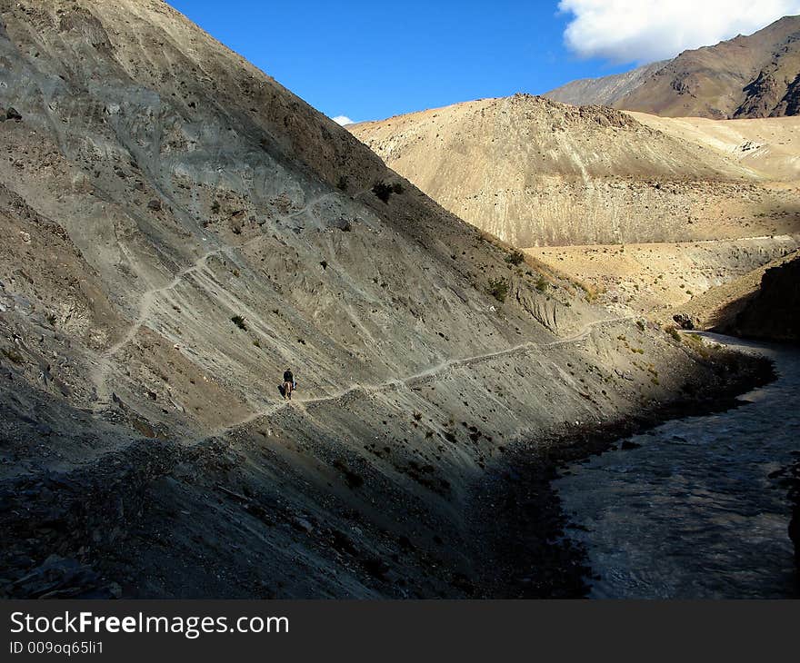 Horseman riding on a path, zanskar valley, Ladakh, India.