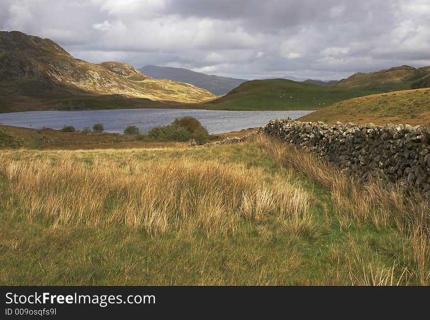 Sunlight breaks through the storm clouds that surround Cregennen Lakes in the Snowdonia National Park, Wales. Sunlight breaks through the storm clouds that surround Cregennen Lakes in the Snowdonia National Park, Wales.