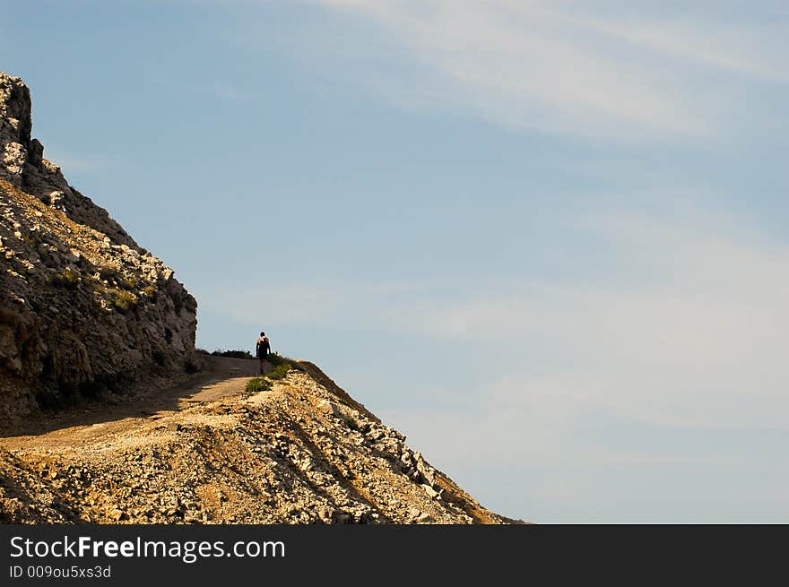 Alone mountaineer on the suny rock and nice sky. Alone mountaineer on the suny rock and nice sky