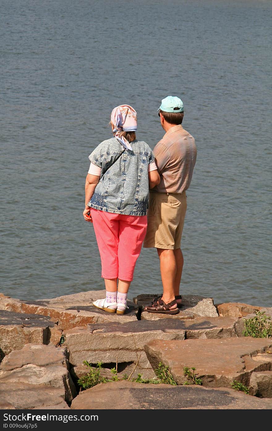 Middle Aged Couple Looking Out Into Ocean