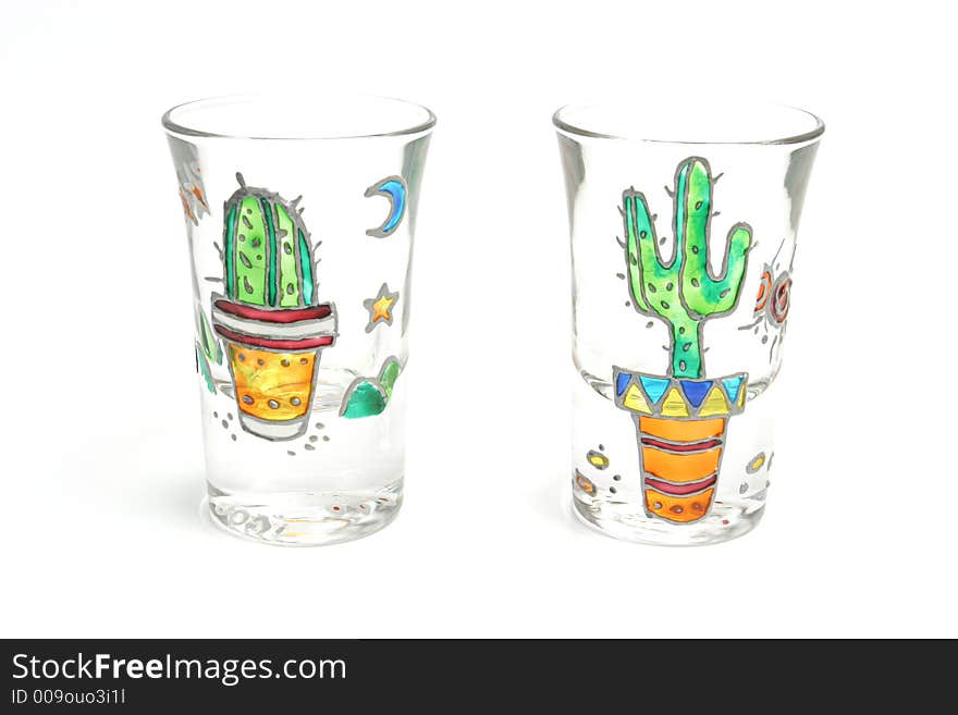 Shooter glasses with cactus painted on them over white backdrop. Shooter glasses with cactus painted on them over white backdrop