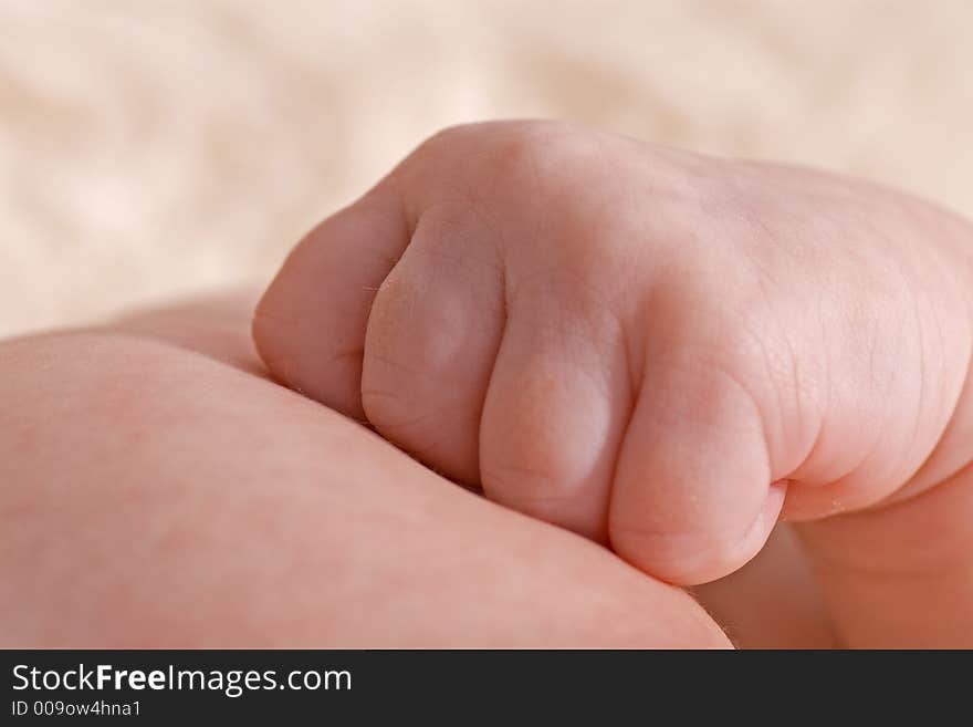 Close up of baby hand resting on chest