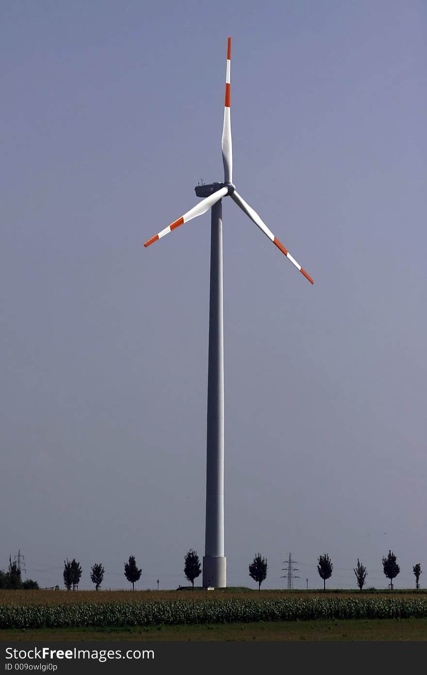 Tall, modern windmill using the wind to generate energy. Tall, modern windmill using the wind to generate energy.