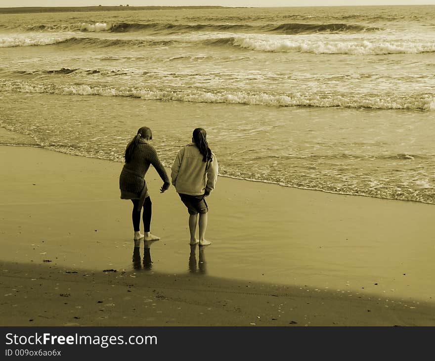 Two girls playing on the beach