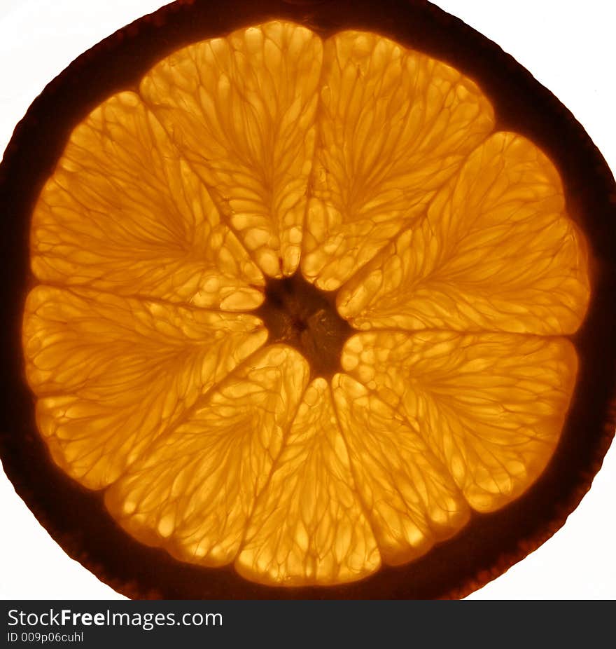 Backlit orange slice on white background