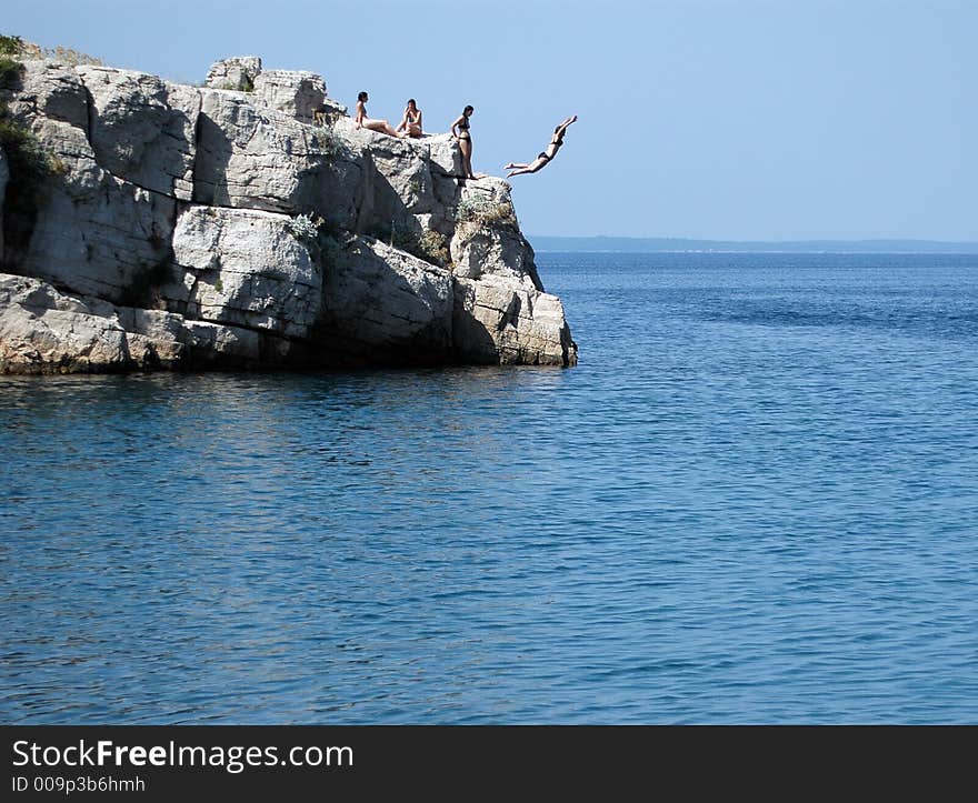 Girl make fun on rock near sea. Girl make fun on rock near sea