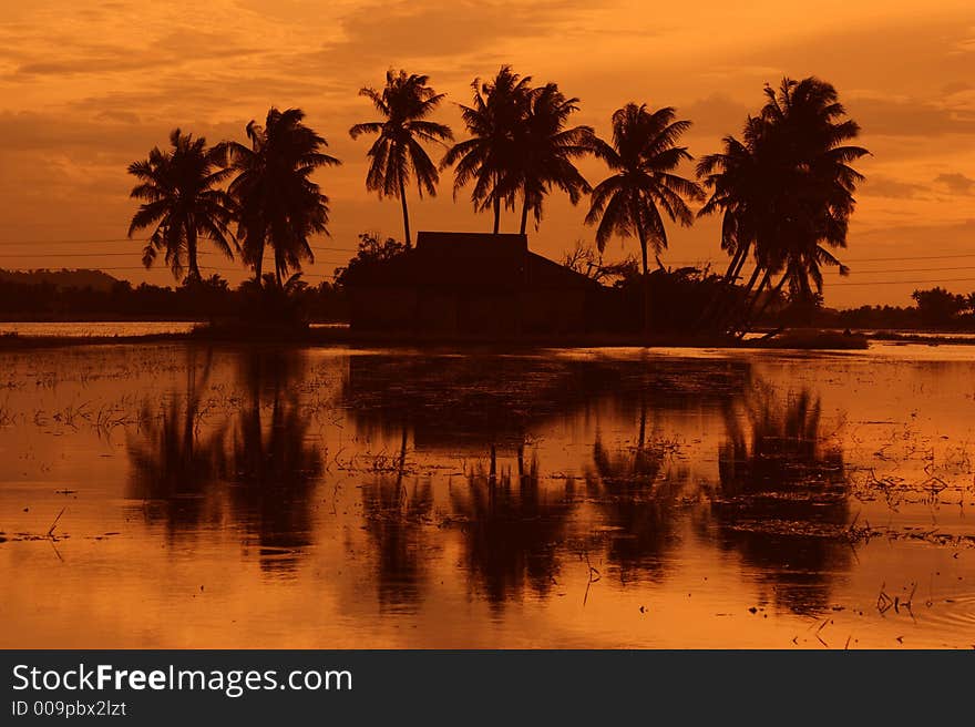 Traditional Malay village sunset view in silhouette. Traditional Malay village sunset view in silhouette.