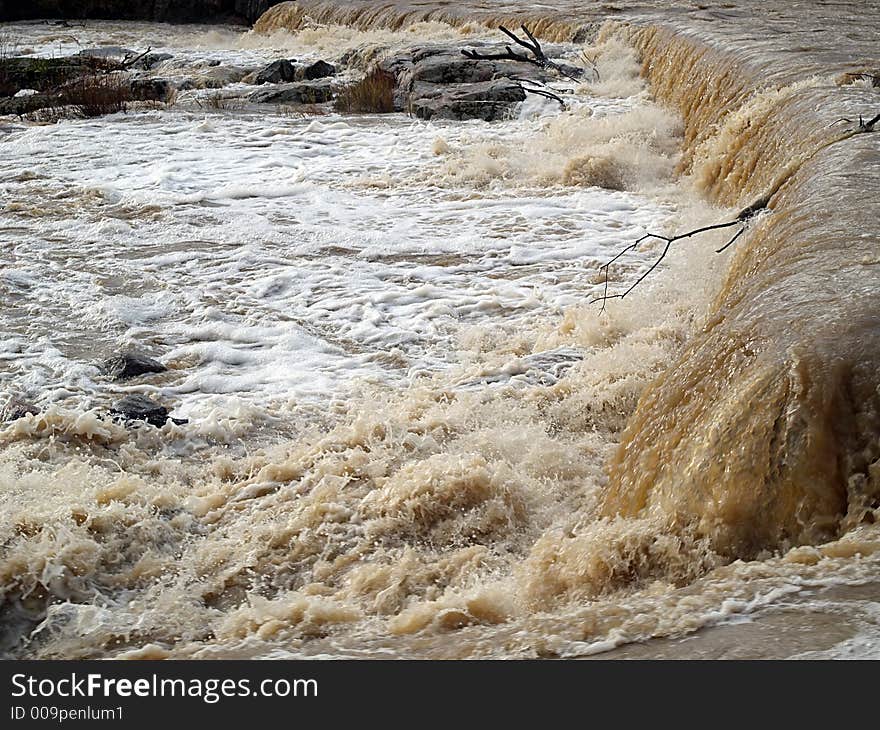 Autumn waterfall in a river, view