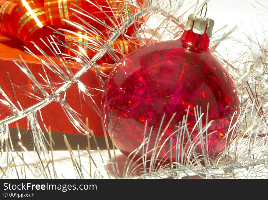 Gift box, christmas ball and tinsel