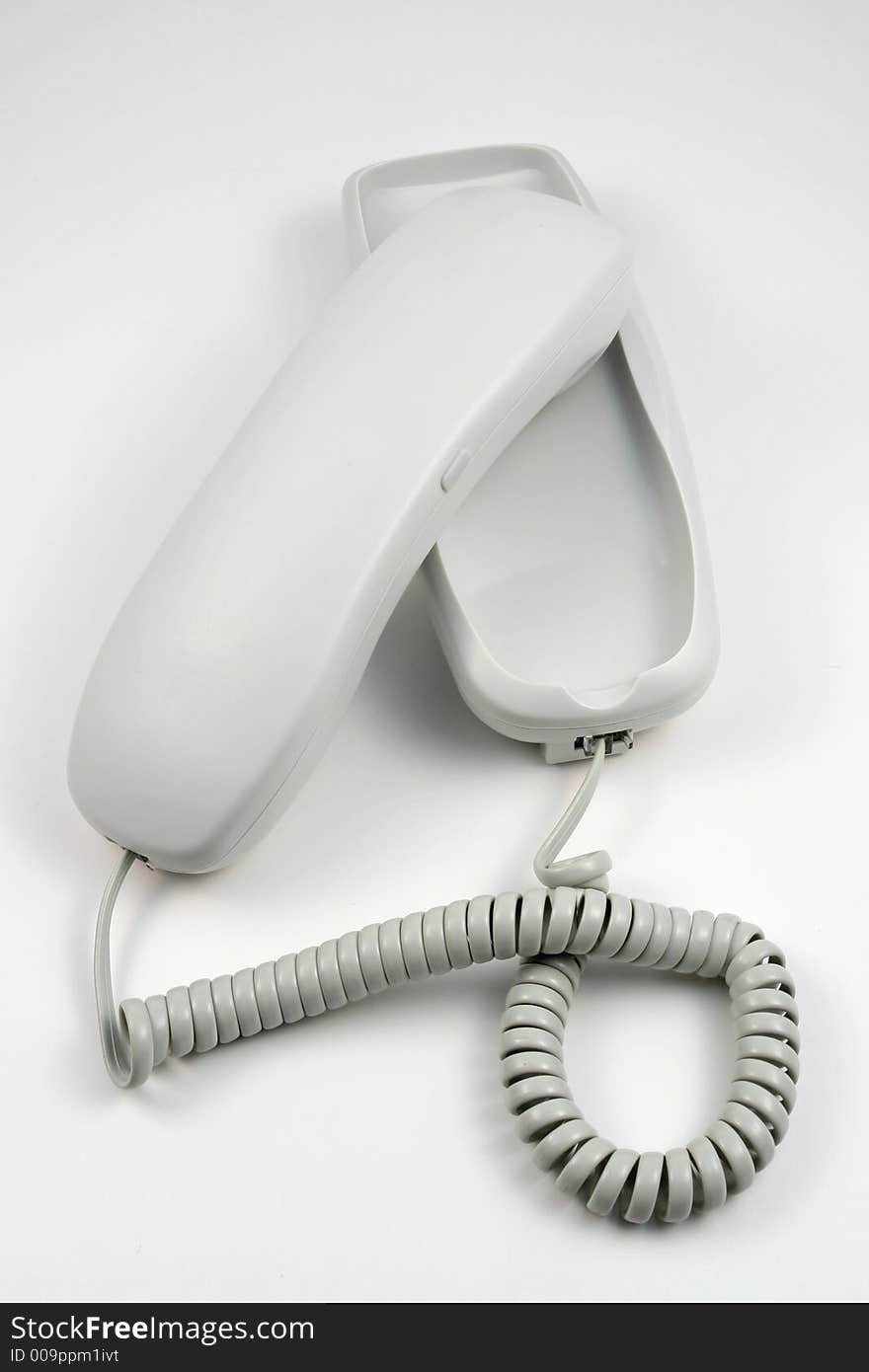 White phone with wire and buttons