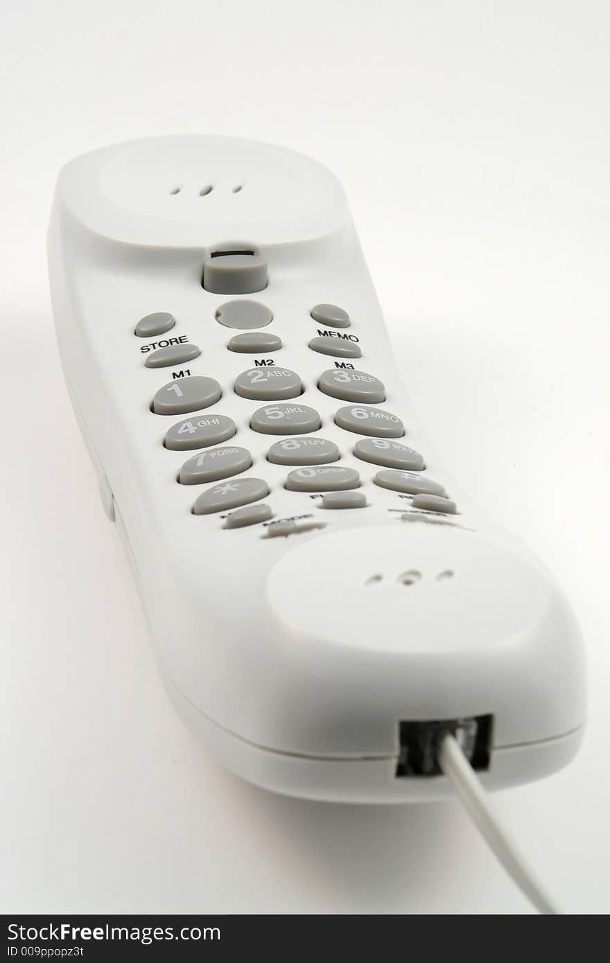 White phone with wire and buttons