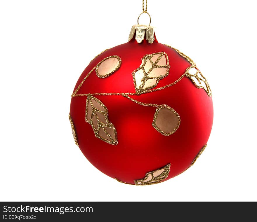 Red ball with golden ornamentation on a white background. Red ball with golden ornamentation on a white background.