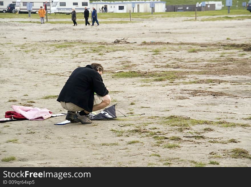 This picture shows a man by the beach during start preparation for a kite. Summer 2006. This picture shows a man by the beach during start preparation for a kite. Summer 2006