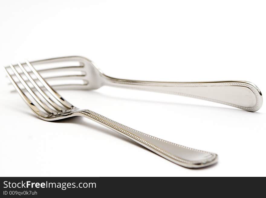 Pair of silver forks set on a white background - isolated