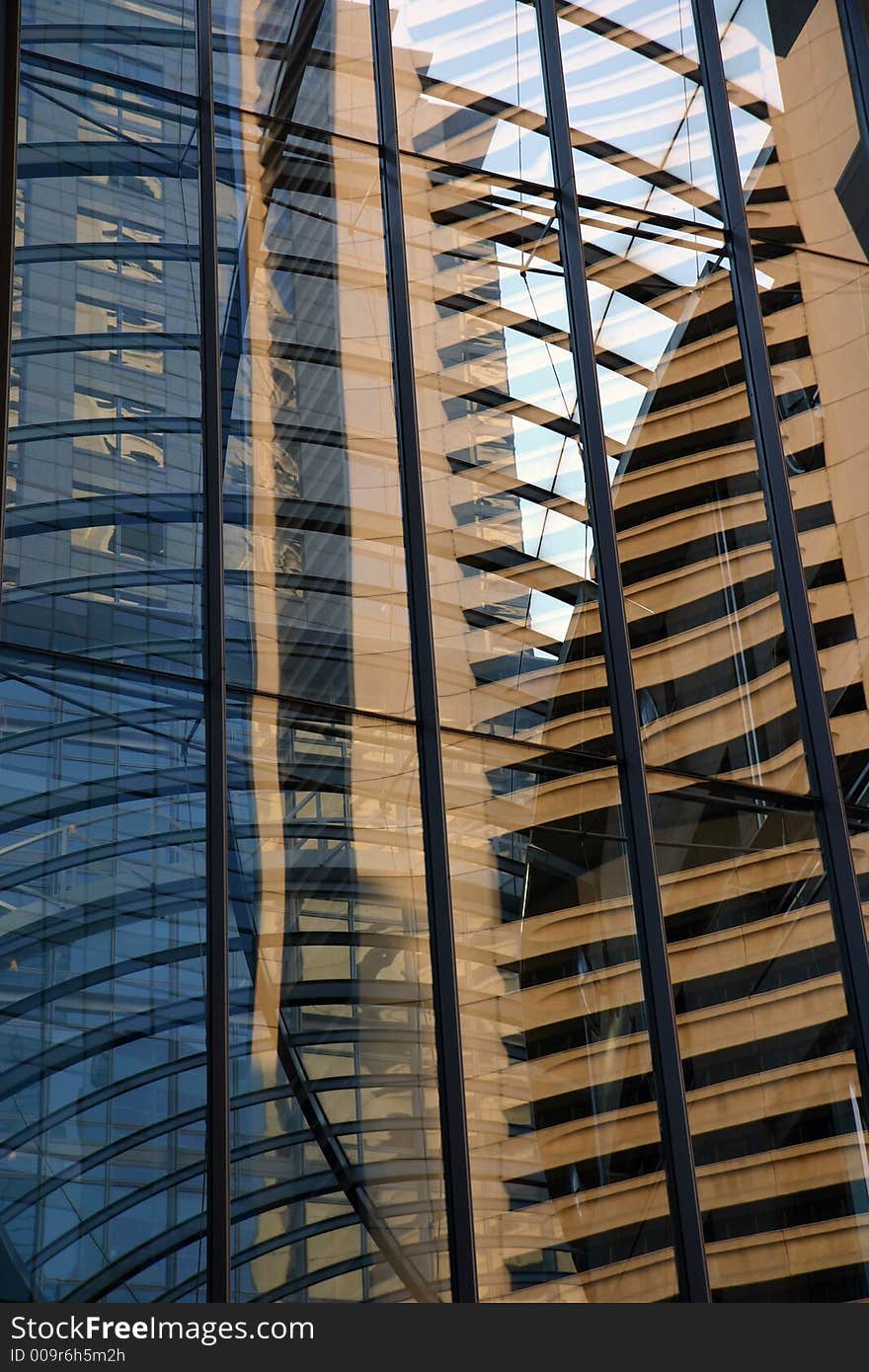 Reflection of urban scene in a corporate building window. Reflection of urban scene in a corporate building window.