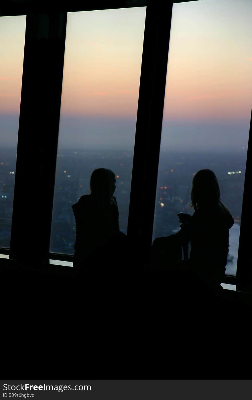 Silhouette of two girls contemplating the sunset from the Sydney tower. Silhouette of two girls contemplating the sunset from the Sydney tower.