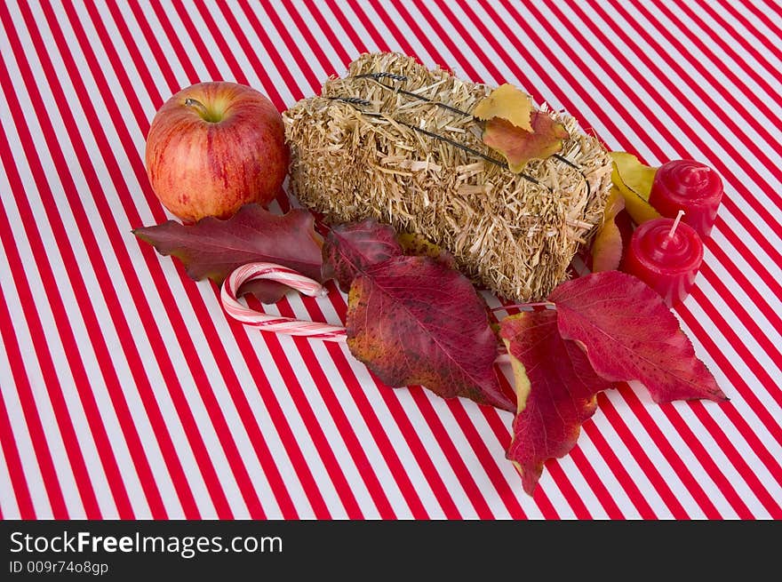 Assorted holiday articles on a red and white striped cloth