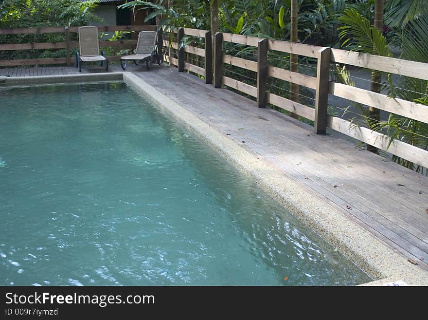 Outdoor pool in jungle with decking