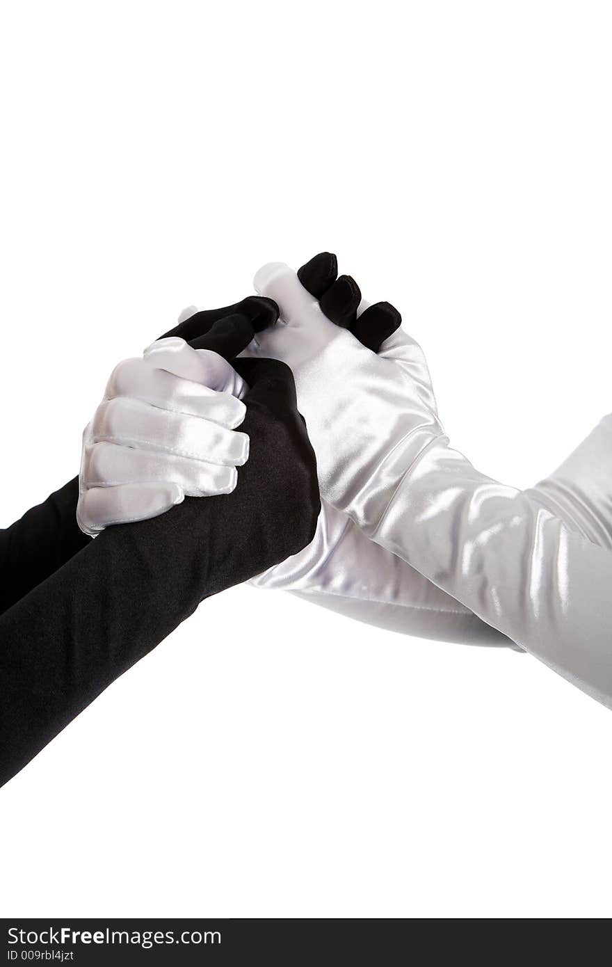 Two women holding hands wearing formal gloves