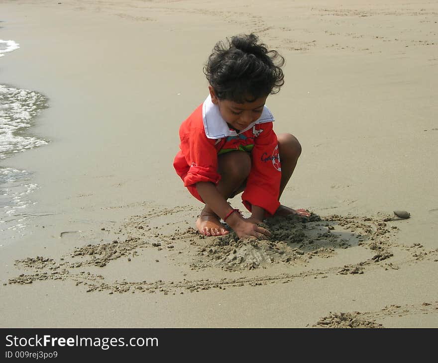 An image showing a child playing on a beach. An image showing a child playing on a beach