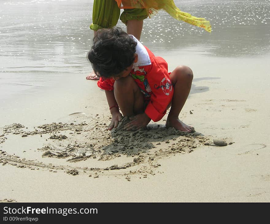 An image showing a child playing on a beach. An image showing a child playing on a beach