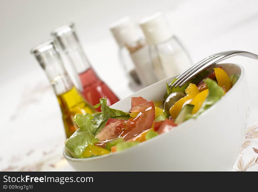 Fresh salad close up with oil and vinegar