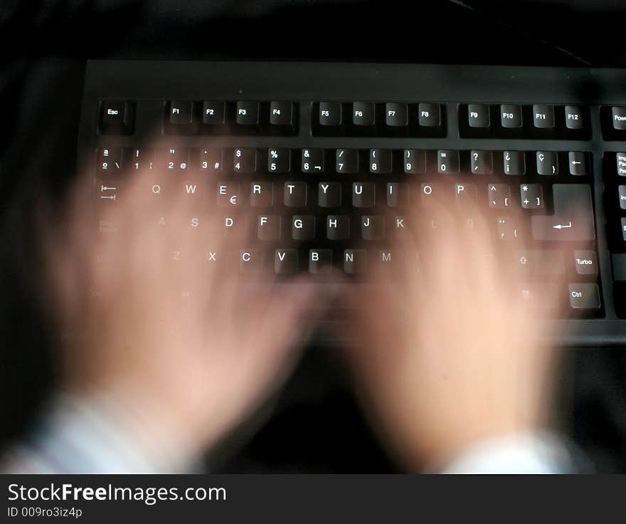 Hard working hands over keyboard