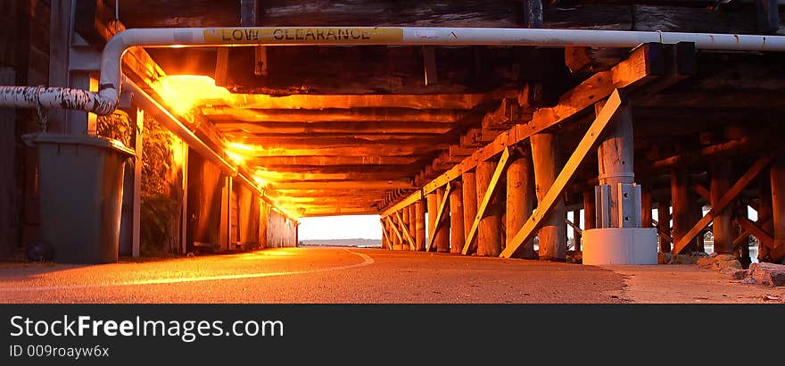 Wooden support of bridge under cycleway showing perspective and danger