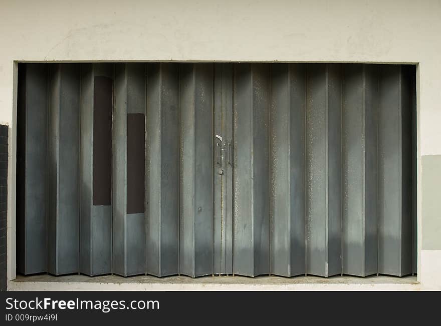 Urban decay-sliding metal door with patterns and walled border