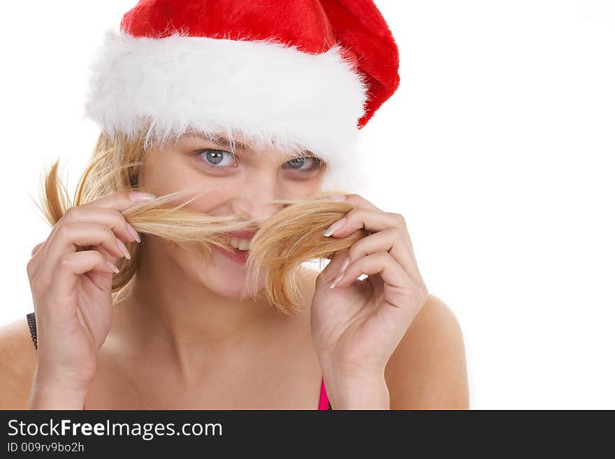 The beautiful girl in a christmas red cap. The beautiful girl in a christmas red cap