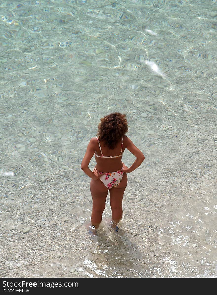 Woman in bikini preparing to swim. Woman in bikini preparing to swim