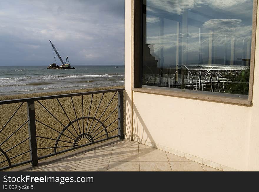 It was a sunny day on the beach and i took this particular photo where we can see clouds reflected on the glass of a bar. It was a sunny day on the beach and i took this particular photo where we can see clouds reflected on the glass of a bar.