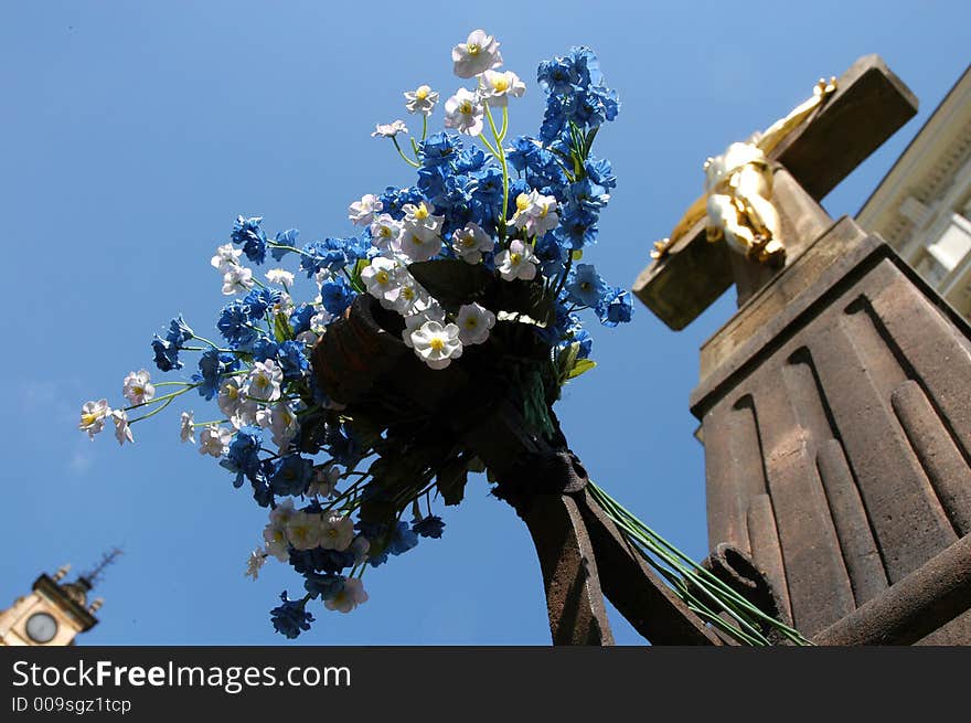 Golden Jesus on crucifix against blue sky