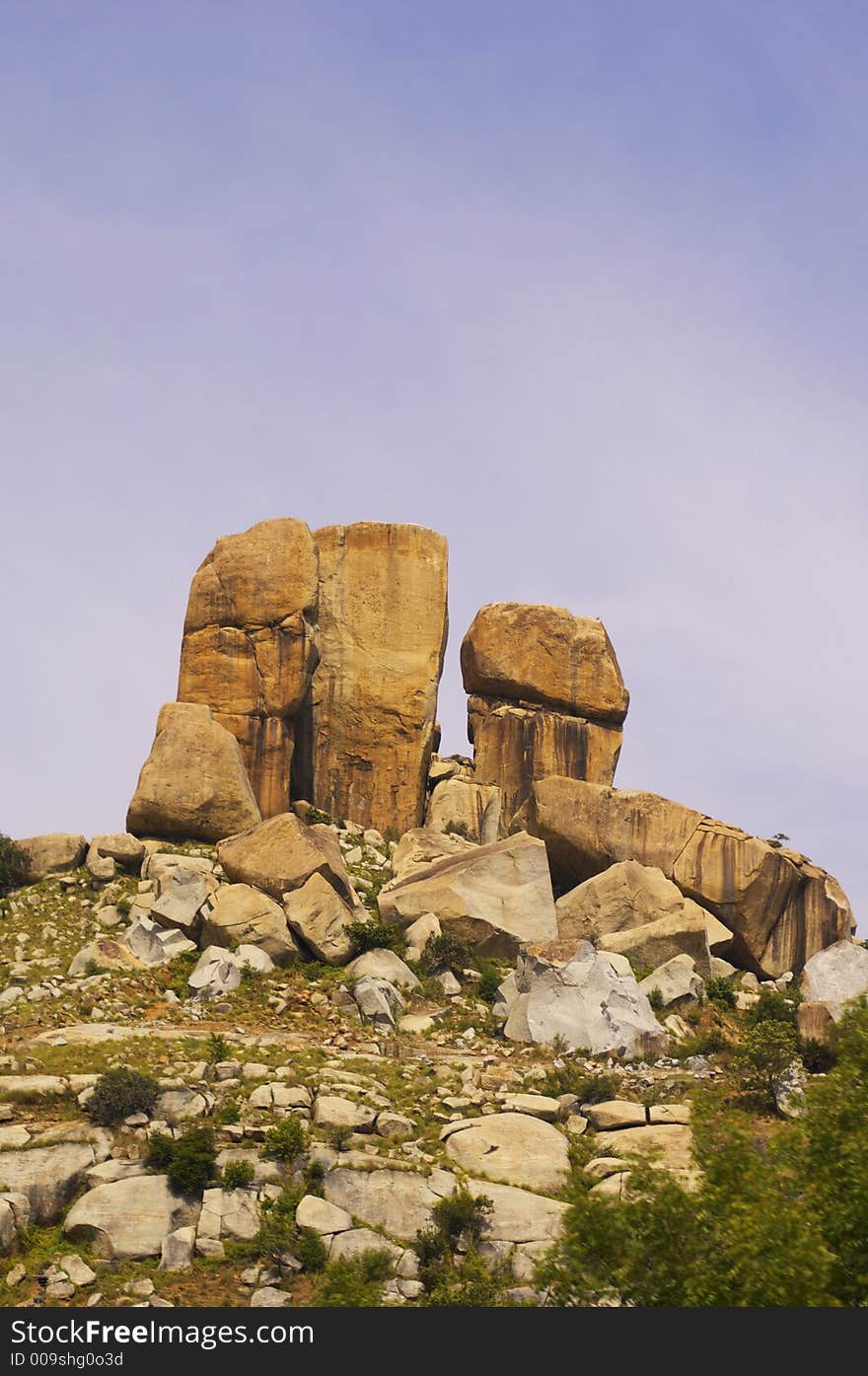 Low angle view of rock formations on top of a hill