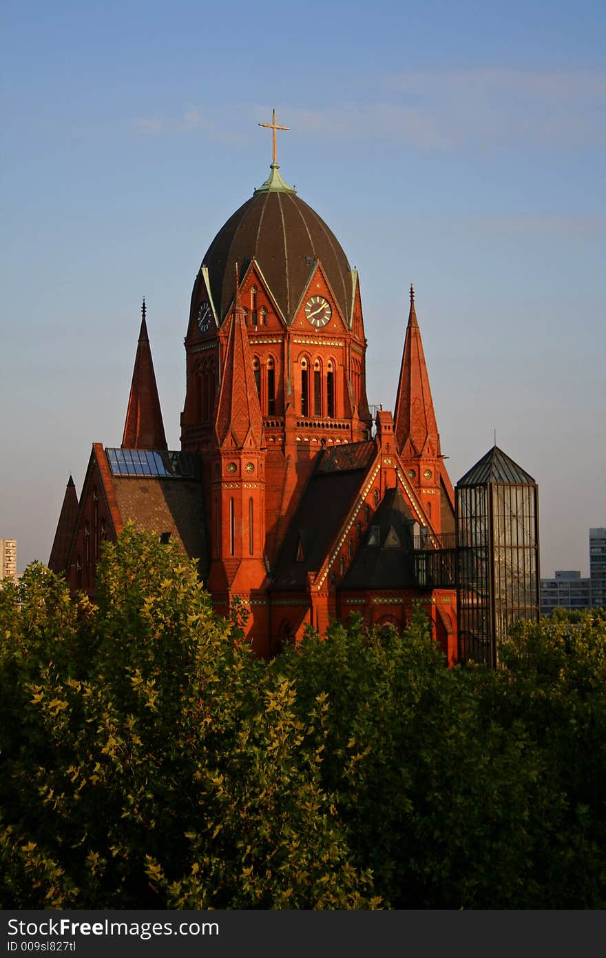 Church amongst trees on blue sky