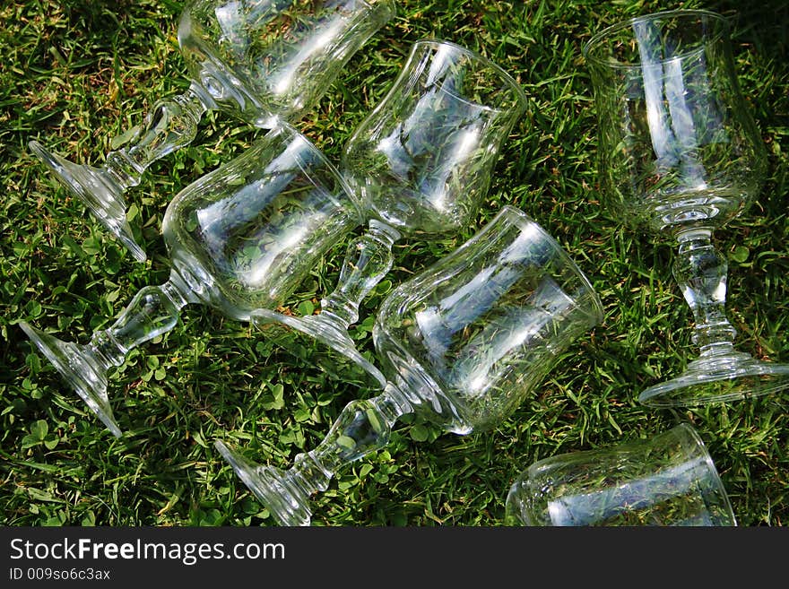 Several wine glasses over grass. Several wine glasses over grass