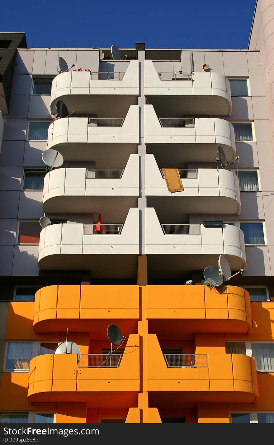 Satellite dishes and orange building. Satellite dishes and orange building