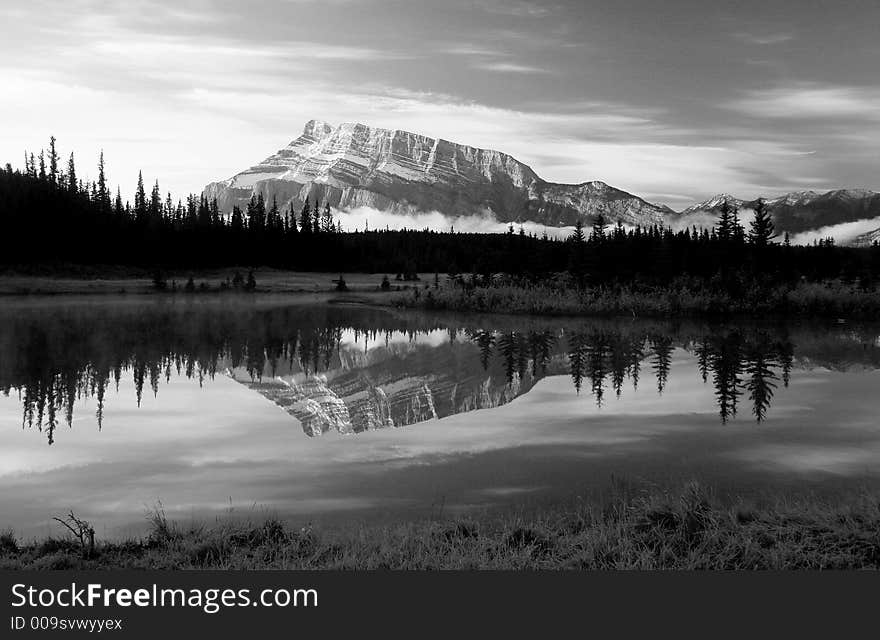 Mt Rundle and its reflectio with low lying fog seen from Cascades Pond. Mt Rundle and its reflectio with low lying fog seen from Cascades Pond.