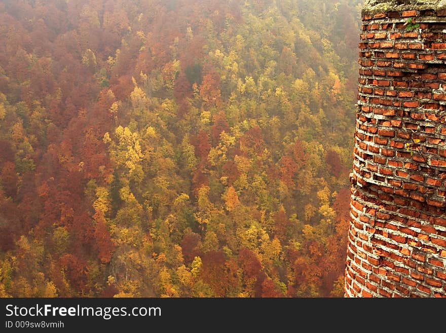 Forest and brick tower in autumn on Transfaragasan road climbing at 2034 m high in Fagaras Mountains. Forest and brick tower in autumn on Transfaragasan road climbing at 2034 m high in Fagaras Mountains