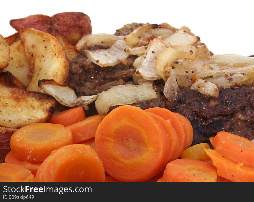 Steak with Carrots and Baked Potato Wedges on White Plate, Close-up. Steak with Carrots and Baked Potato Wedges on White Plate, Close-up