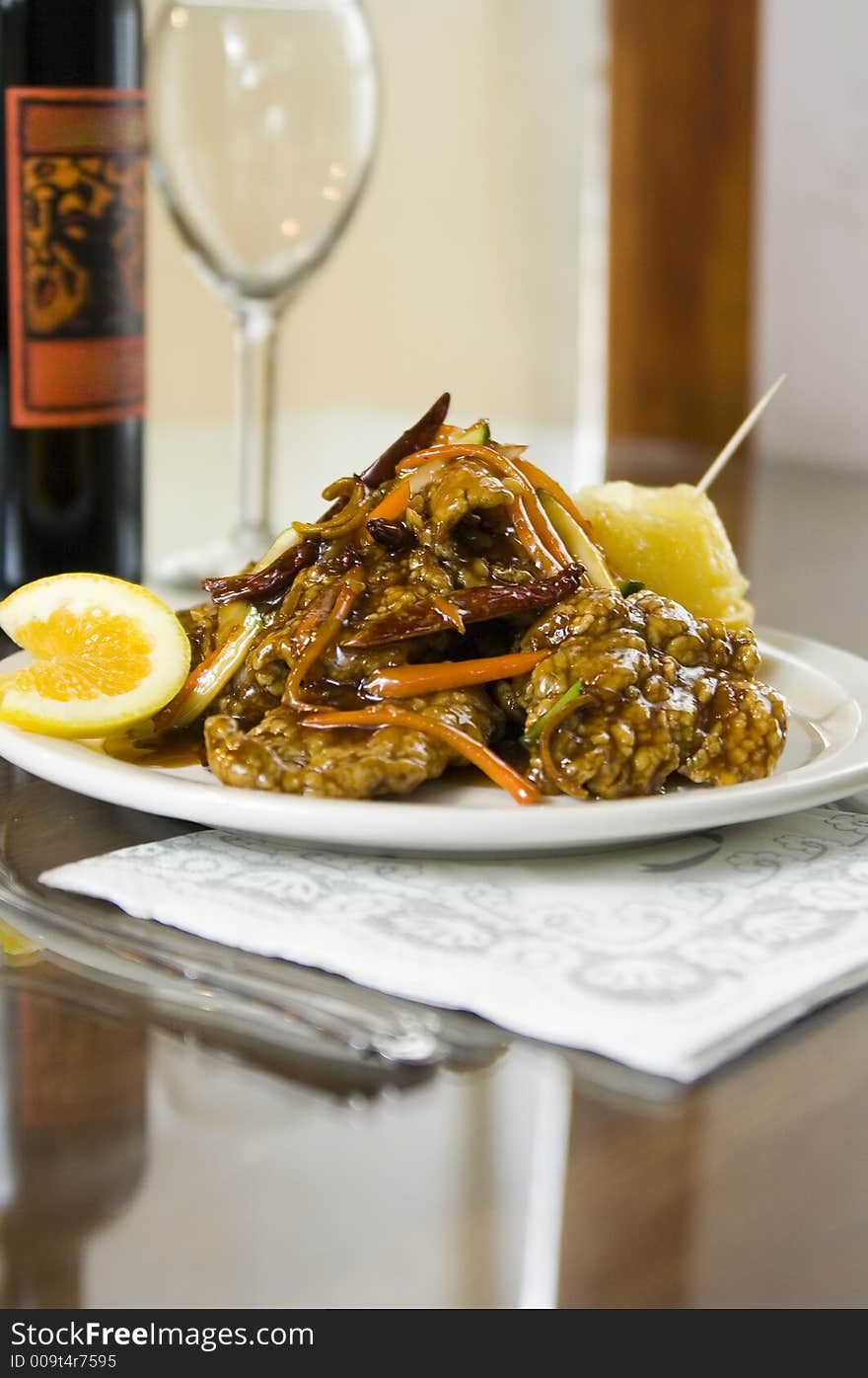 Shoot of glazed tempura orange beef with wine background. vertical view. Shoot of glazed tempura orange beef with wine background. vertical view