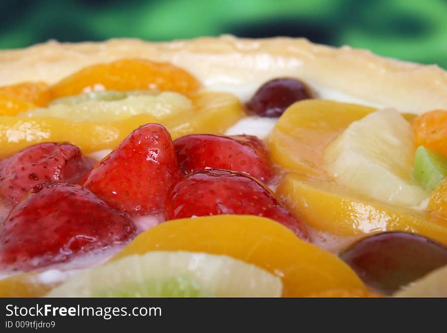 Summer garden fruits in a sweet glazed cream pie dessert, macro close up with copy space