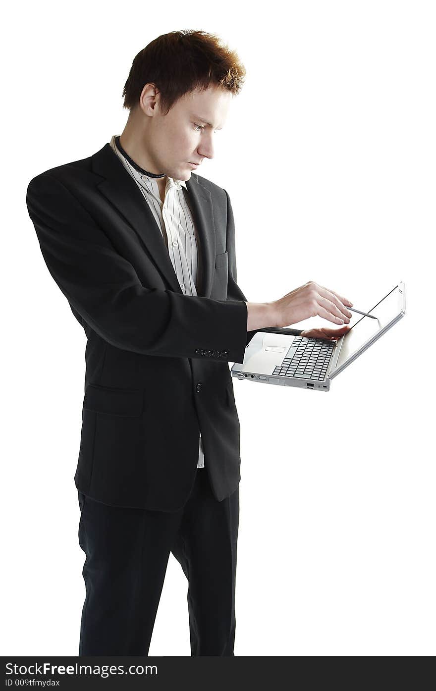 Isolated young businessman using a touchscreen laptop. Isolated young businessman using a touchscreen laptop