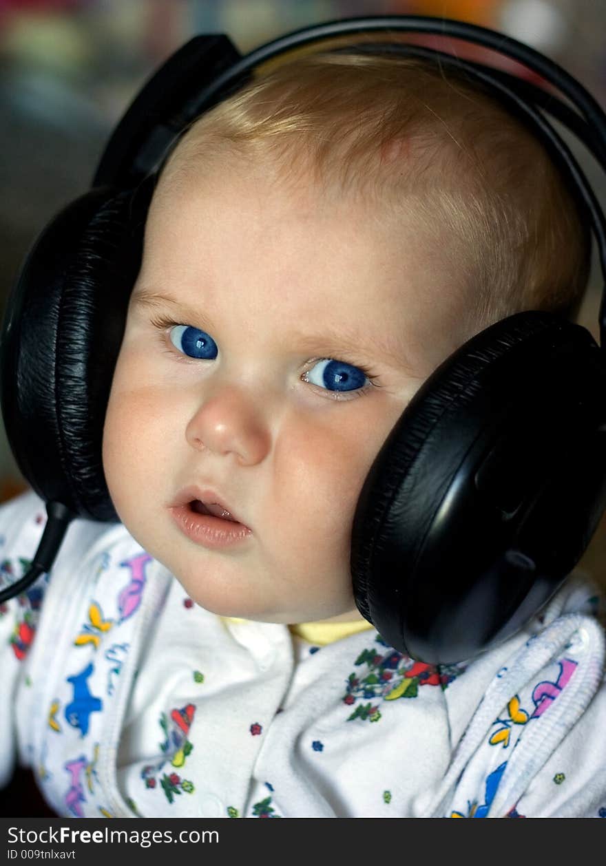 A photo of a baby in headphones